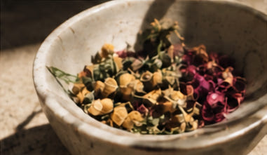 Loose herbs and flowers in a ceramic bowl