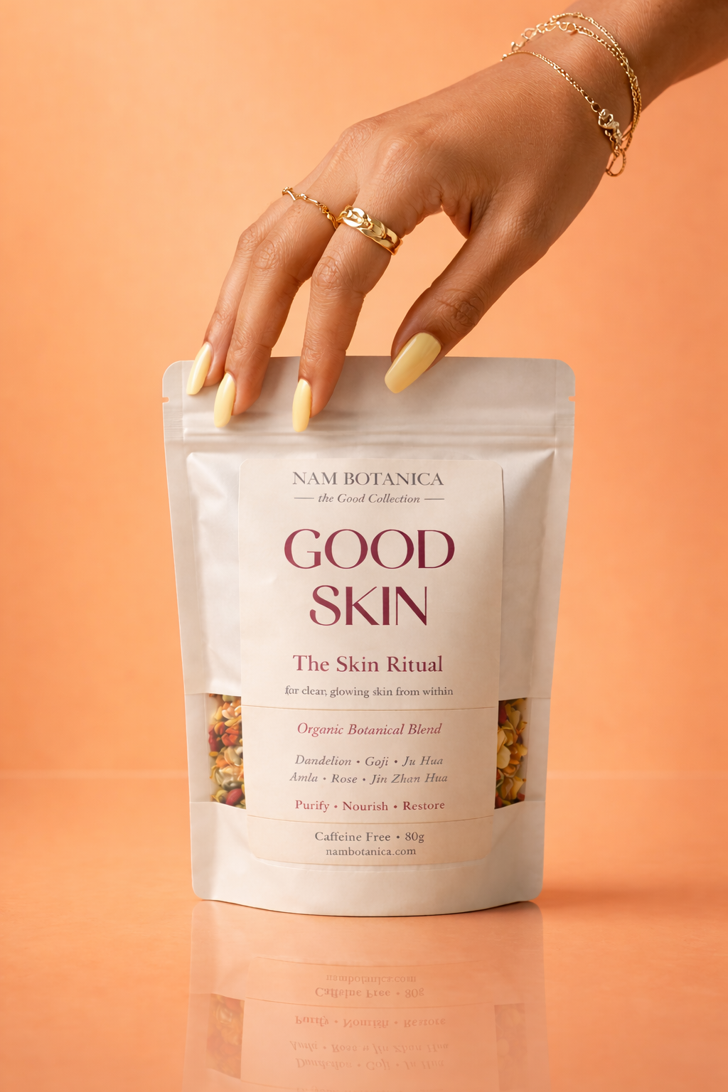 Woman holding Nam Botanica Good Skin Tea pouch – The Skin Ritual Organic Botanical Blend, 80g Caffeine Free